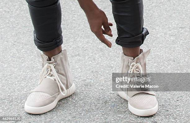 Kanye West, speculated to be wearing the Yeezy 3 sneakers 'Yeezy 750 Boost', arrives at the Roc Nation Pre-GRAMMY Brunch on February 7, 2015 in...