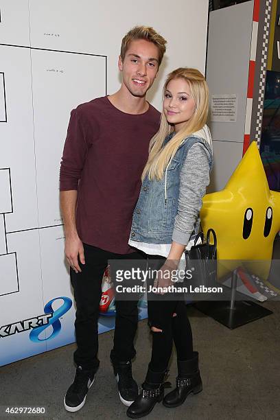 Austin North and Olivia Holt attend the Dylan Riley Snyder Races Into His 18th Year With Nintendo at K1 Speed on February 7, 2015 in Gardena,...