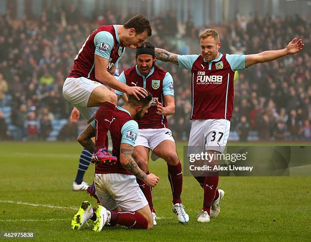 Goalscorer Ashley Barnes of Burnley jumps on Danny Ings of Burnley as he celebrates scoring the opening goal during the Barclays Premier League match...