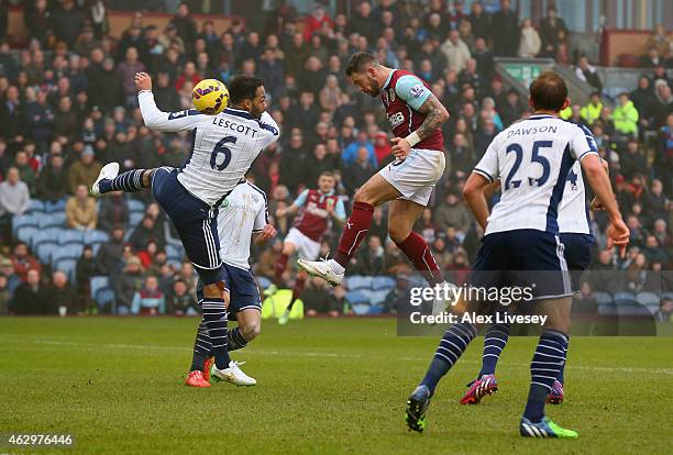 Danny Ings of Burnley heads in their second goal past Joleon Lescott of West Brom during the Barclays Premier League match between Burnley and West...