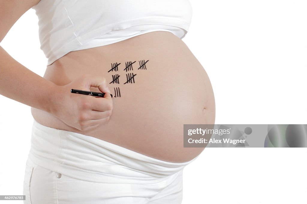 Woman counts the weeks till birth of her baby