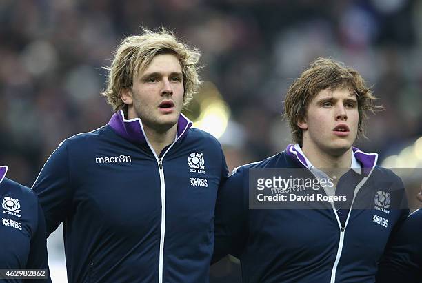 Richie Gray and his brother Jonny Gray of Scotland line up for the anthems during the RBS Six Nations match between France and Scotland at Stade de...