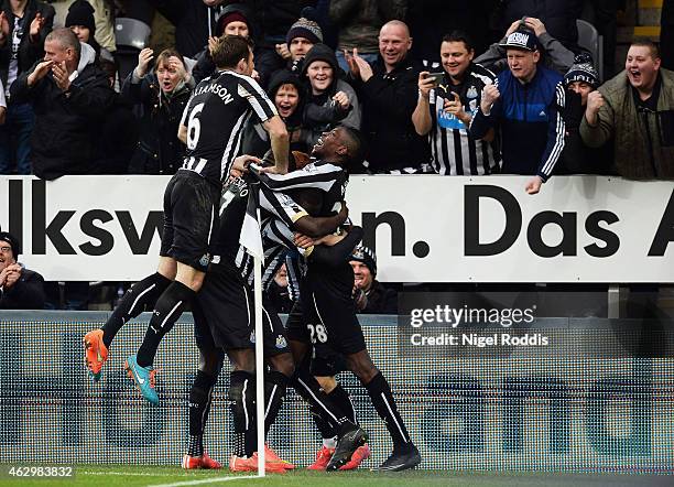 Jack Colback of Newcastle United celebrates with fans and team mates as he scores their first goal during the Barclays Premier League match between...