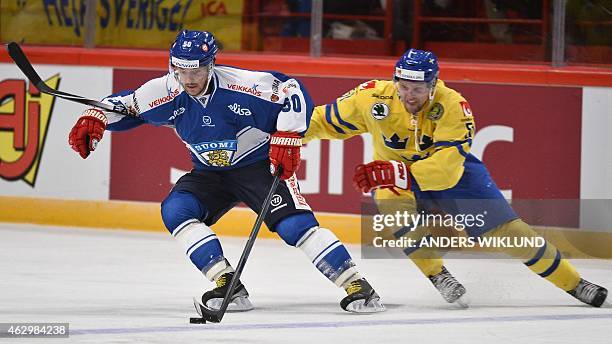 Finland's Juhamatti Aaltonen and Sweden's Jonas Ahnelov vie during the Euro Hockey Tour Ice Hockey match Sweden vs Finland at the Ericsson Globe...