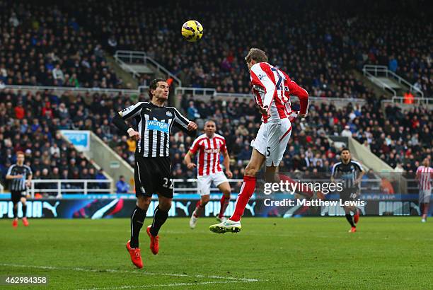 Peter Crouch of Stoke City outjumps Daryl Janmaat of Newcastle United to score their first and equalising goal during the Barclays Premier League...