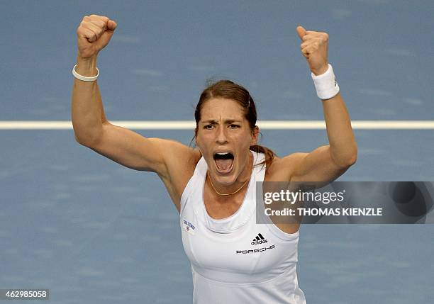 Germany's Andrea Petkovic celebrates after she defeated Australia's Jarmila Gajdosova by 6-3, 3-6, 8-6 in their tennis match of the FedCup World...