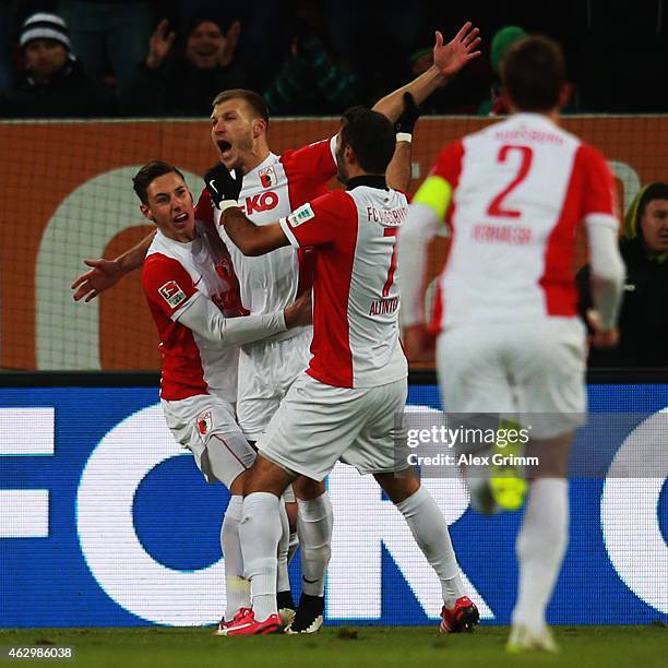 Ragnar Klavan of Augsburg celebrates his team's first goal with team mates Dominik Kohr, Halil Altintop and Paul Verhaegh during the Bundesliga match...