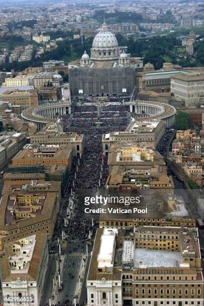 An aerial view of a crowded St. Peter's Square and St. Peter's Basilica covered with scaffoldings as Pope John Paul II celebrates the Padre Pio...