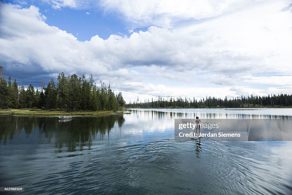 Woman standing  on up paddle board