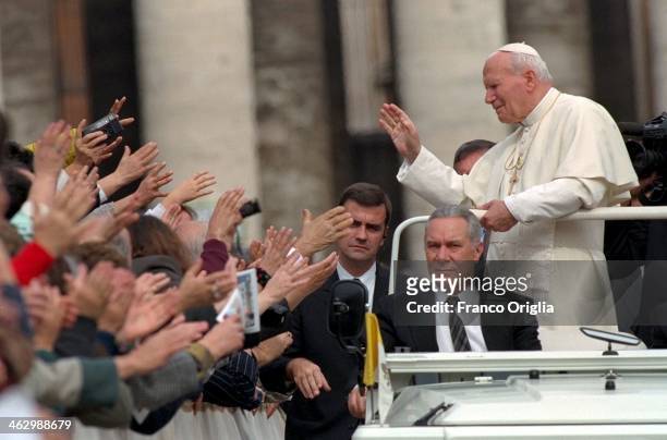 Pope John Paul II waves to the faithful from his Popemobile during his weekly general audience in St. Peter's Square on October 2, 1996 in Vatican...