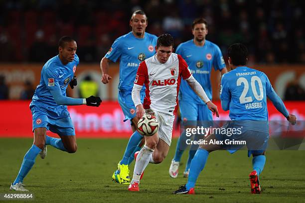 Pierre-Emile Hojbjerg of Augsburg is challenged by Bamba Anderson, Alexander Meier, Marco Russ and Makoto Hasebe of Frankfurt during the Bundesliga...