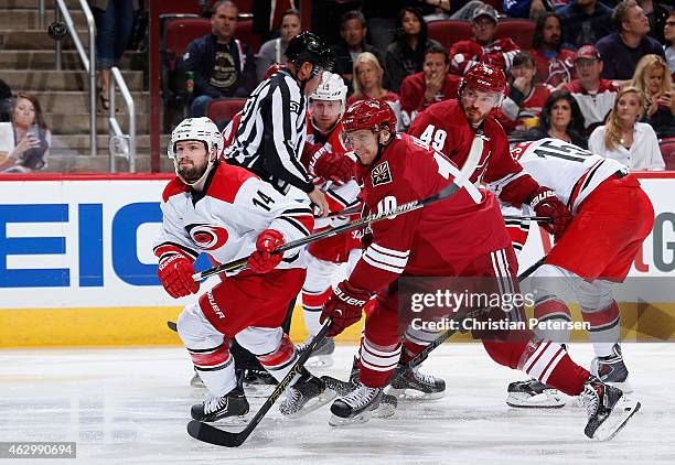 Nathan Gerbe of the Carolina Hurricanes flips the puck past Martin Erat of the Arizona Coyotes during the NHL game at Gila River Arena on February 5,...