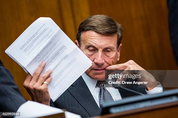 Rep. John Mica looks over notes during a House Oversight Committee hearing concerning the security of the Healthcare.gov website, in the Rayburn...