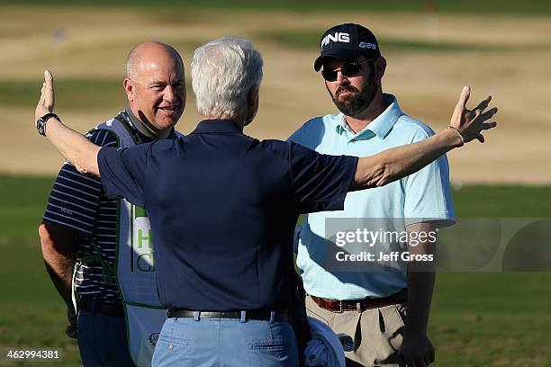 Former U.S. President Bill Clinton talks with Edward Loar, right, before the first round of the Humana Challenge in partnership with the Clinton...