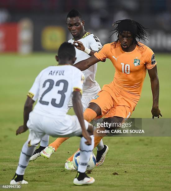 Ivory Coast's forward Gervinho challenges Ghana's defender Harrison Afful during the 2015 African Cup of Nations final football match between Ivory...