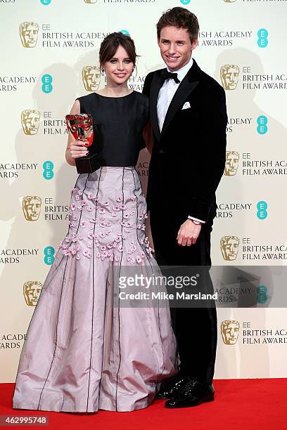Felicity Jones and Eddie Redmayne pose with the Outstanding British Film award for 'The Theory of Everything' in the winners room at the EE British...