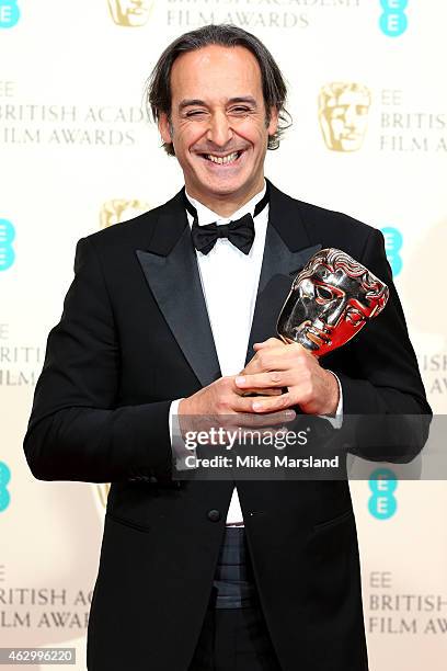 Composer Alexandre Desplat, winner of the Original Music award for the movie 'The Grand Budapest Hotel', poses in the winners room at the EE British...