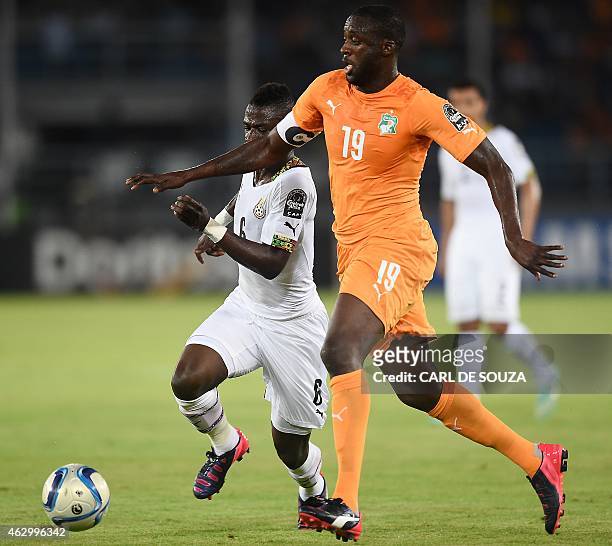 Ghana's midfielder Afriyie Acquah challenges Ivory Coast's midfielder Yaya Toure during the 2015 African Cup of Nations final football match between...