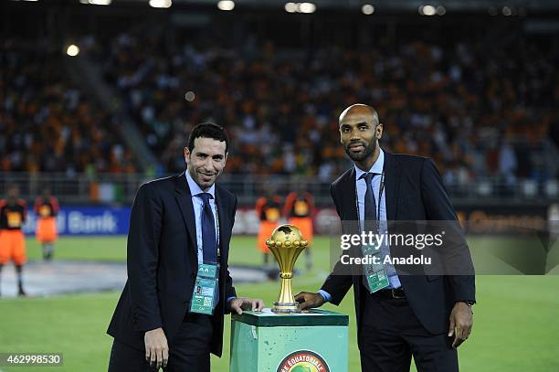 Footballer Frederic Kanoute and Egyptian midfielder Mohamed Aboutrika deliver the 2015 African Cup of Nations trophy ahead of the final football...