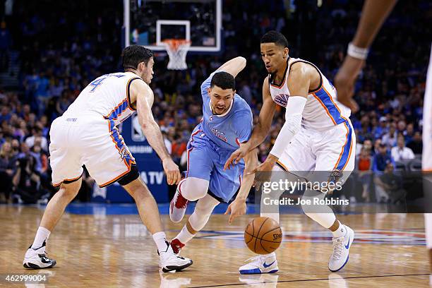 Andre Roberson and Nick Collison of the Oklahoma City Thunder defend against Austin Rivers of the Los Angeles Clippers during the game at Chesapeake...