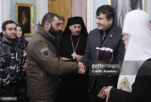 Former president of Georgia Mikheil Saakashvili and Patriarch Filaret attend a ceremony held for the 29 volunteer Georgian people fighting against...