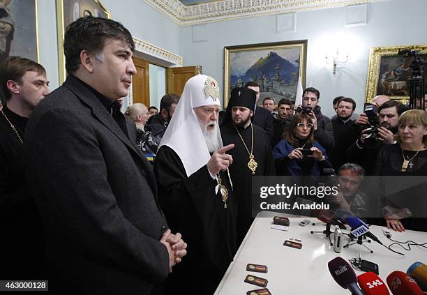 Former president of Georgia Mikheil Saakashvili and Patriarch Filaret attend a ceremony held for the 29 volunteer Georgian people fighting against...