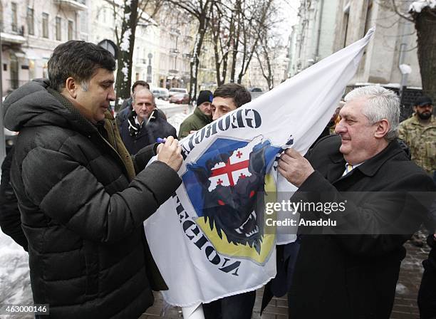 Former president of Georgia Mikheil Saakashvili signs the flag of Georgian legion after a ceremony held for the 29 volunteer Georgian people fighting...