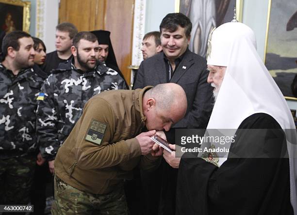 Former president of Georgia Mikheil Saakashvili and Patriarch Filaret attend a ceremony held for the 29 volunteer Georgian people fighting against...