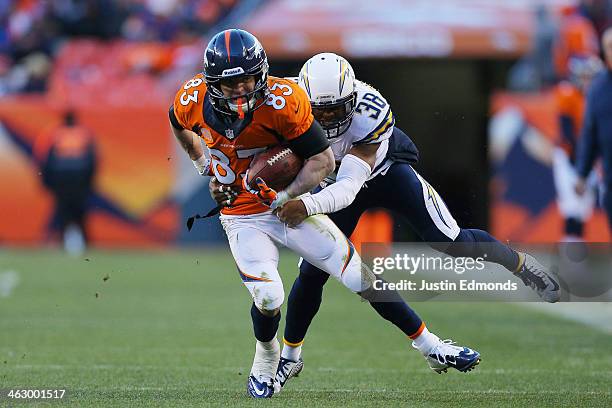 Wes Welker of the Denver Broncos tries to avoid the tackle of Marcus Gilchrist of the San Diego Chargers during the AFC Divisional Playoff Game at...