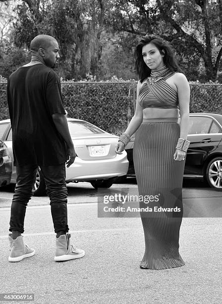 Kim Kardashian and Kanye West, speculated to be wearing the Yeezy 3 sneakers 'Yeezy 750 Boost', arrive at the Roc Nation Grammy Brunch 2015 on...