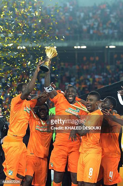 Ivory Coast's players celebrate with the trophy at the end of the 2015 African Cup of Nations final football match between Ivory Coast and Ghana in...