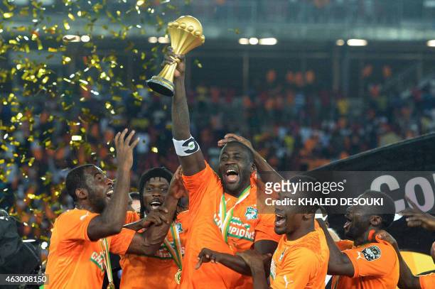 Ivory Coast's midfielder Yaya Toure raises the trophy at the end of the 2015 African Cup of Nations final football match between Ivory Coast and...