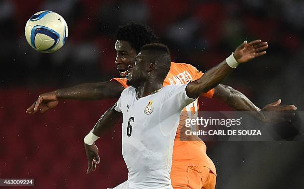 Ivory Coast's forward Wilfried Bony heads the ball with Ghana's midfielder Afriyie Acquah during the 2015 African Cup of Nations final football match...