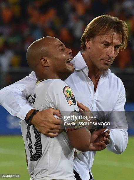 Ghana's midfielder Andre Ayew is comforted by Ivory Coast's coach Herve Renard at the end of the 2015 African Cup of Nations final football match...