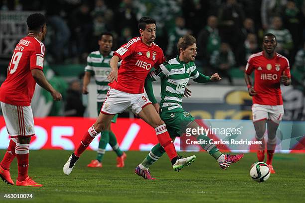 Sporting's midfielder Adrien Silva vies with Benfica's midfielder Andre Almeida during the Primeira Liga match between Sporting CP and SL Benfica at...