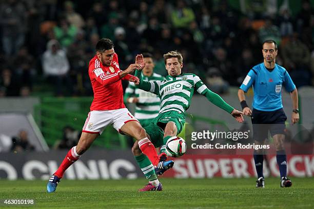 Sporting's midfielder Adrien Silva vies with Benfica's forward Eduardo Salvio during the Primeira Liga match between Sporting CP and SL Benfica at...