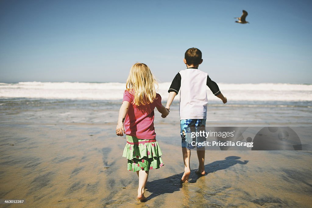 Children walking together on beach