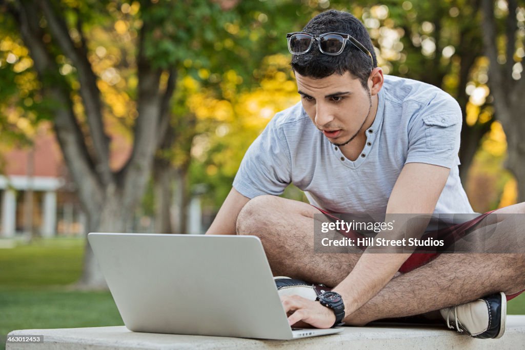 Middle Eastern man using laptop