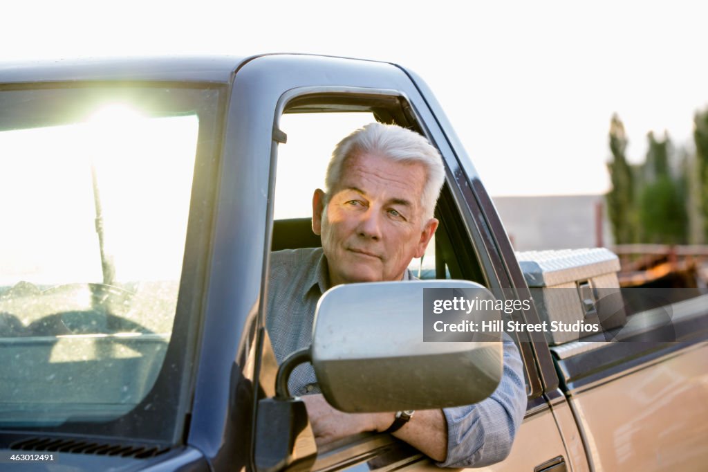 Caucasian rancher driving truck