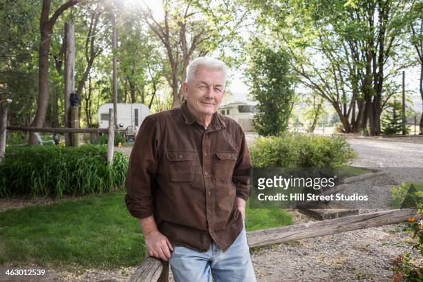 caucasian man standing at campground - railing stockfoto's en -beelden