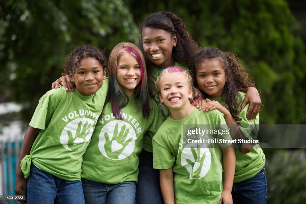 Girls wearing volunteer t-shirts outdoors