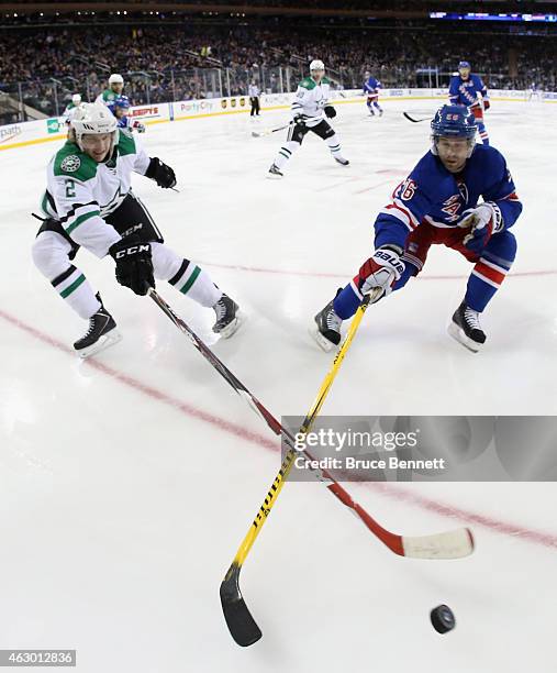 Jyrki Jokipakka of the Dallas Stars and Martin St. Louis of the New York Rangers pursue the puck during the first period at Madison Square Garden on...