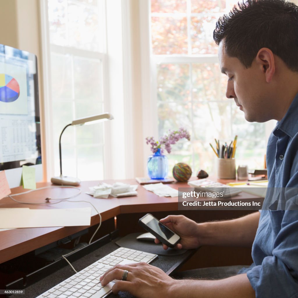 Pacific Islander businessman working at desk