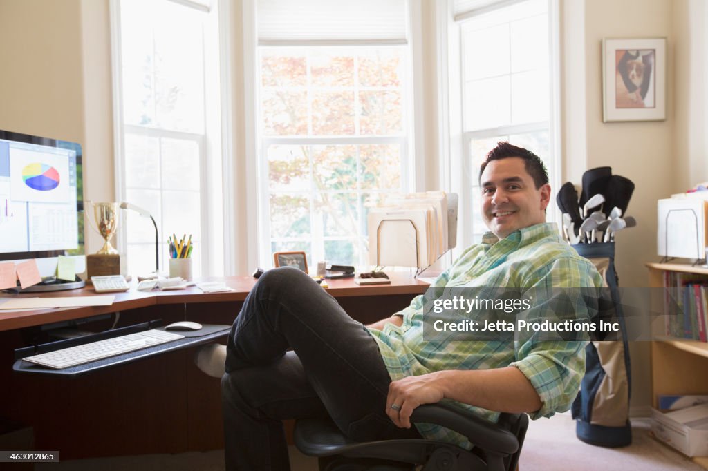 Pacific Islander businessman smiling at desk