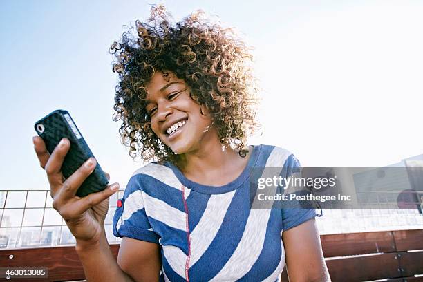 mixed race woman using cell phone - mobile phone reading low angle stock pictures, royalty-free photos & images