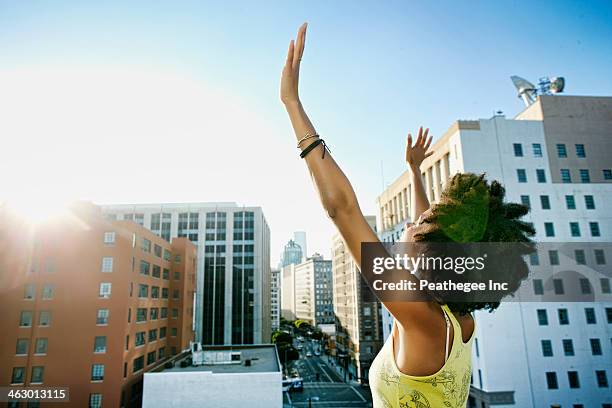 mixed race woman on urban rooftop - fest 2013 day 1 stock-fotos und bilder