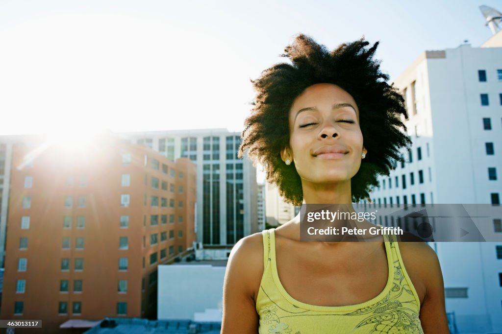 Mixed race woman on urban rooftop