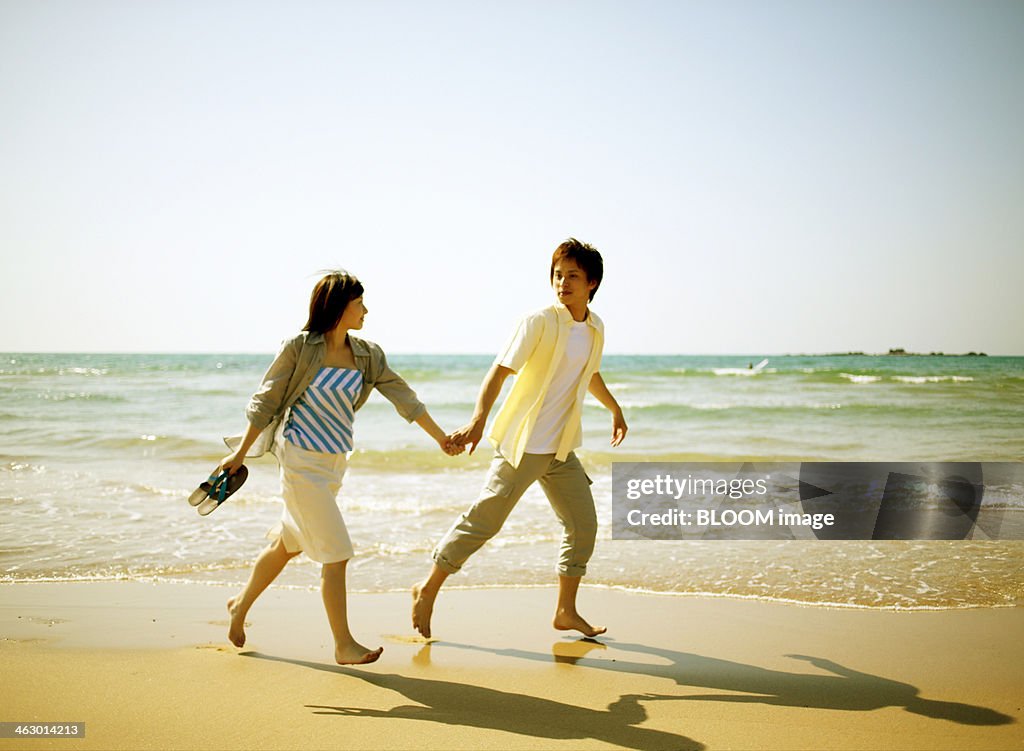 Couple Walking On Beach