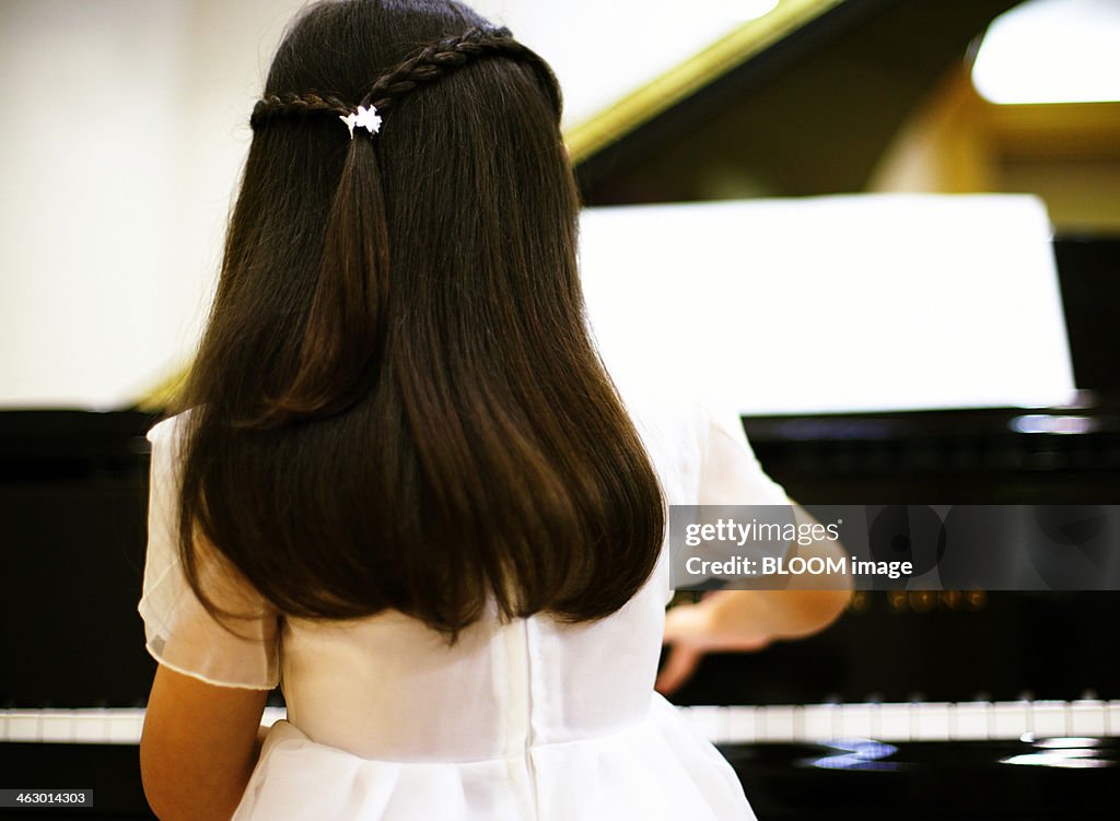 Close-up Of A Girl Playing Piano