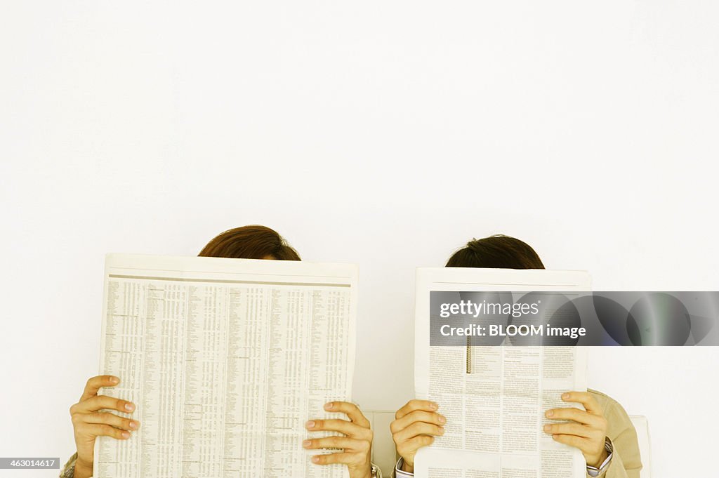 Two People Reading Newspaper